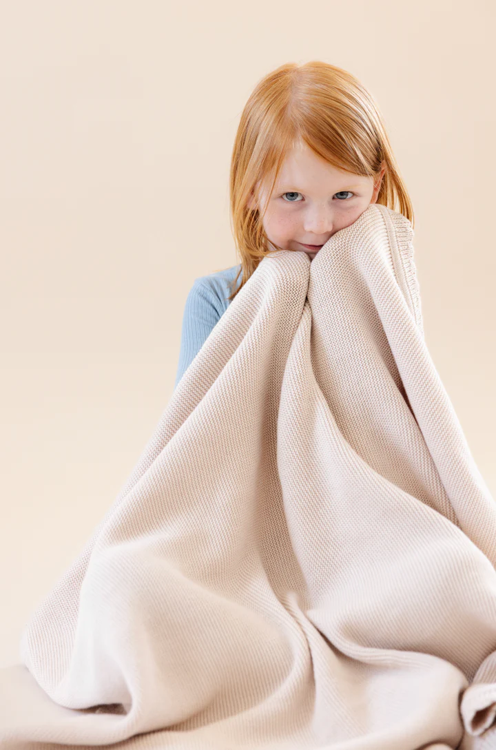 Child wrapped in soft nap mat fabric